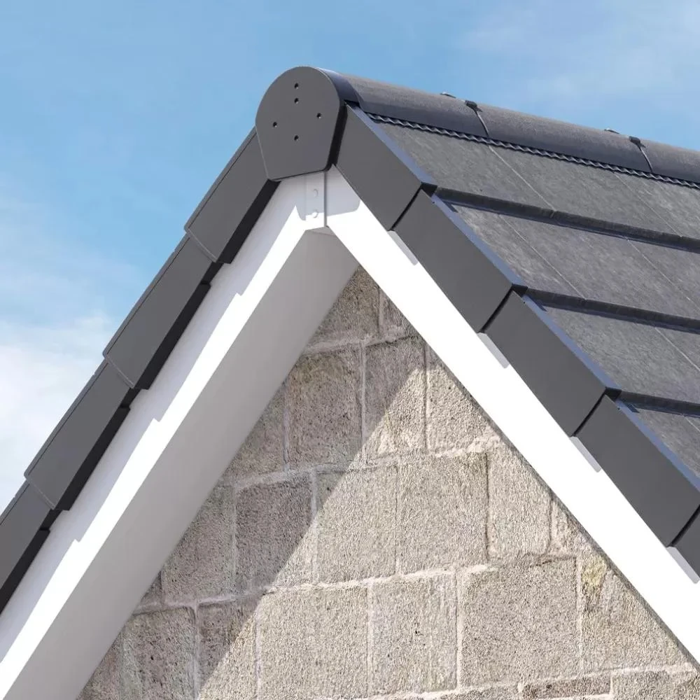 Grey dry verge caps fitted along a tiled gable above white fascia boards