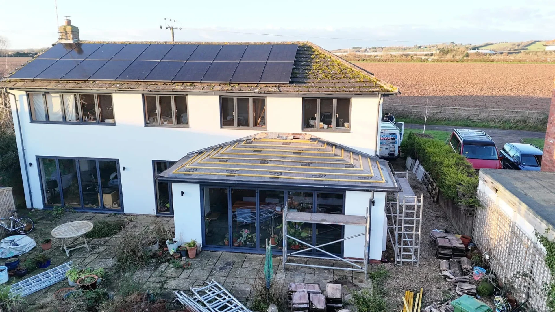 House roof during installation with fitted dark tiles and exposed battens