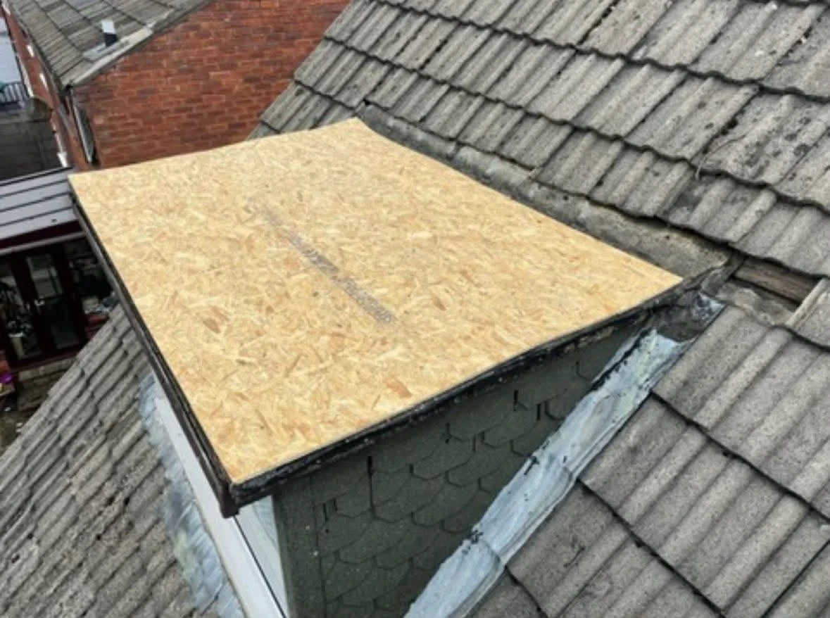 Exposed timber decking on a dormer flat roof during replacement