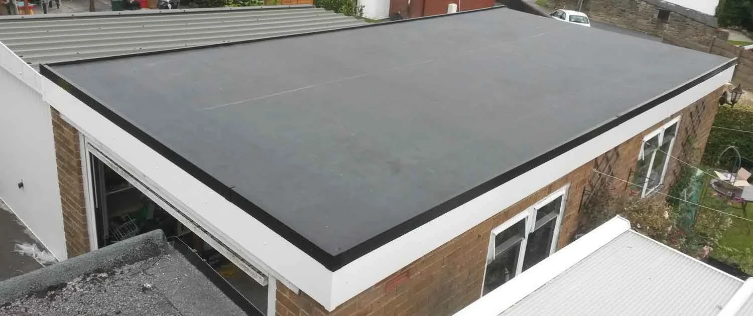 Finished flat roof with white perimeter fascia and black rainwater gutter