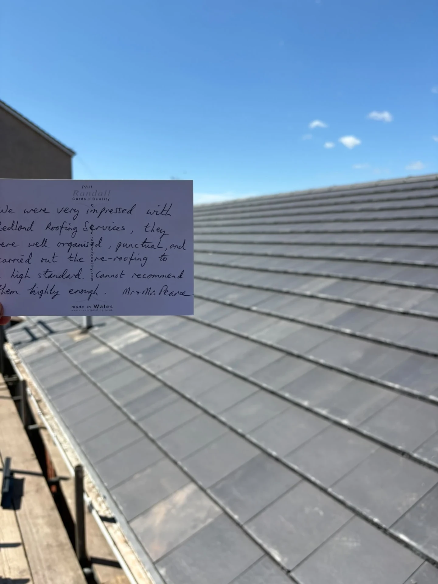 Grey tiled roof with a handwritten note obscuring part of the photograph
