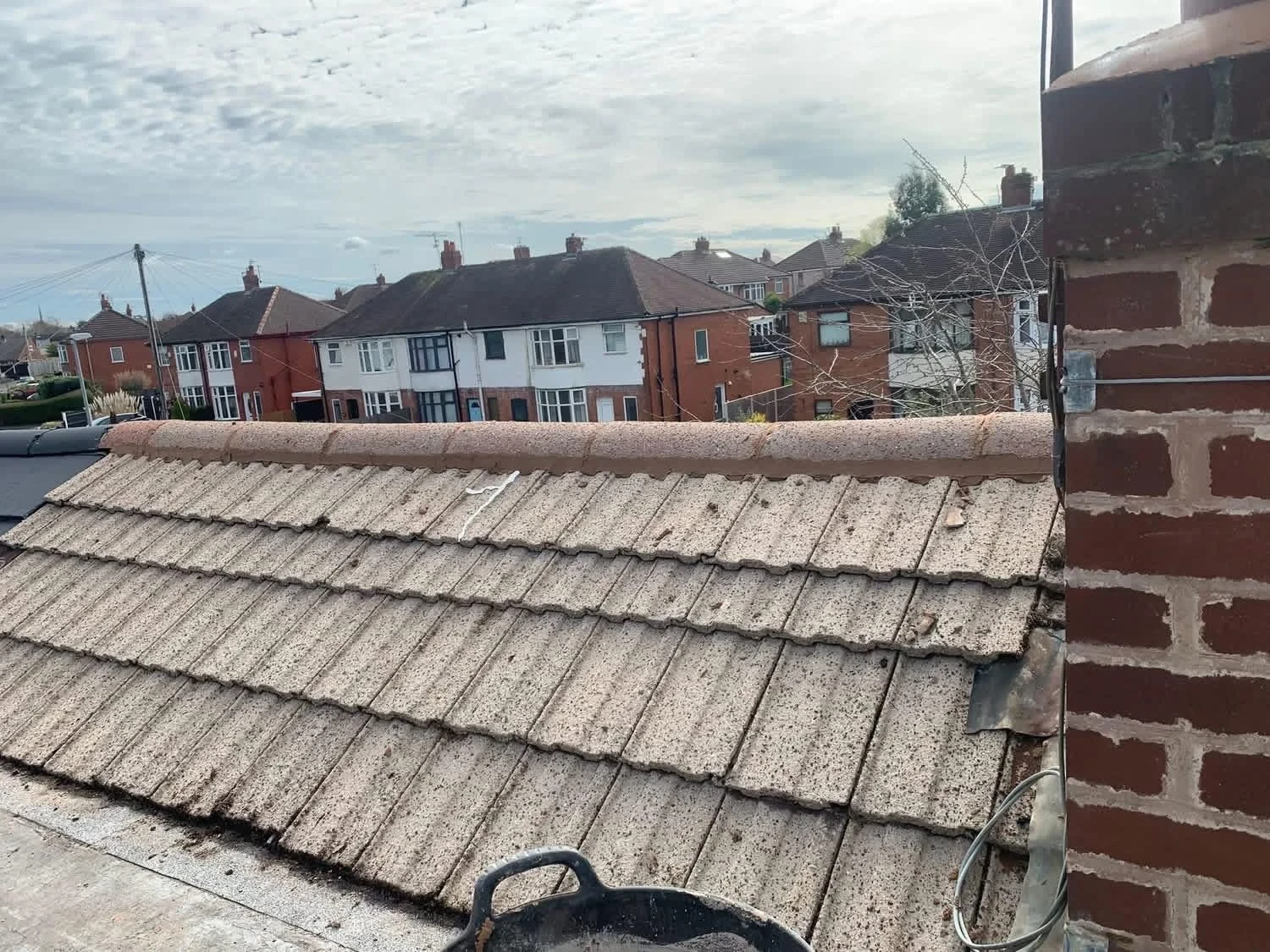 Concrete tiled roof and ridge after roof repair work